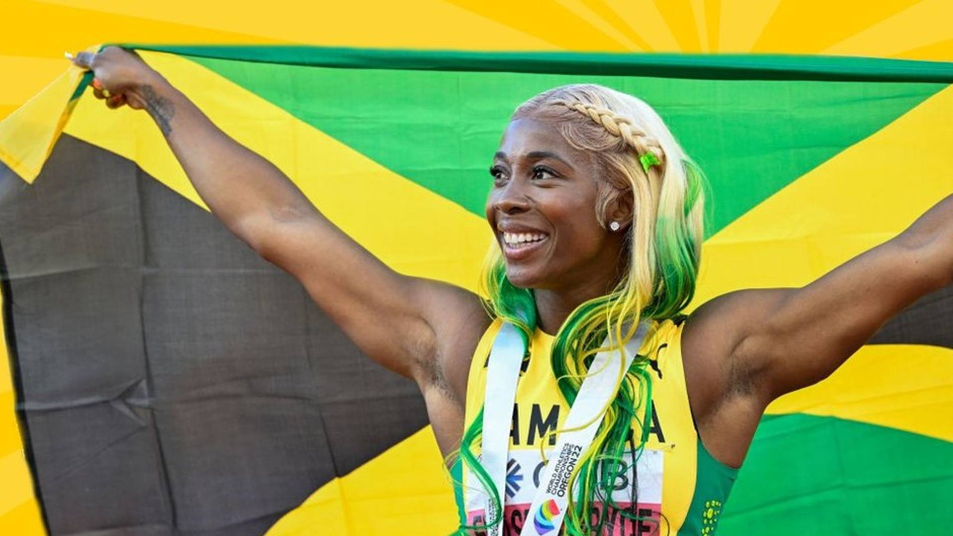 Shelly-Ann Fraser holding the Jamaican flag (Credits: Twitter)