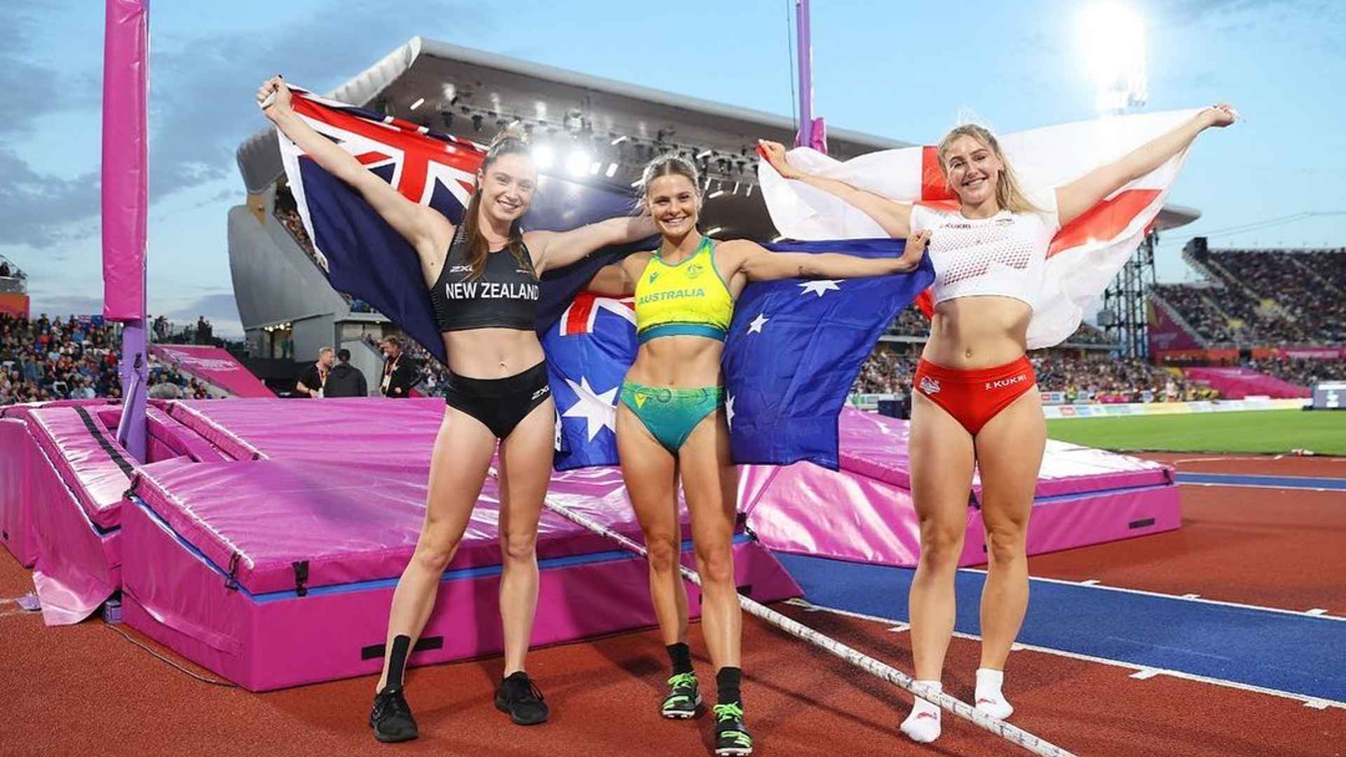 Nina Kennedy (middle) and other medalists holding their nation's flags at the Commonwealth Games 2022 (Image Credits - Instagram/ @ninakennedy_)