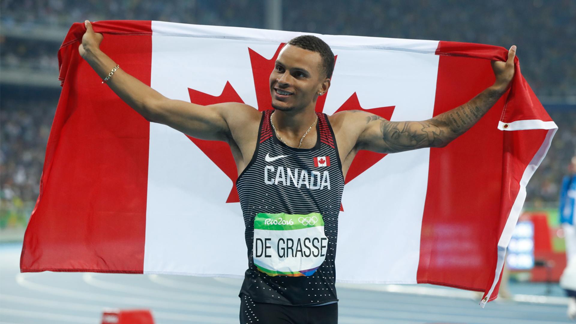 Andre De Grasse with the Canadian flag at the Rio Olympics 2020 (Credits- Canadian Olympic Committee)